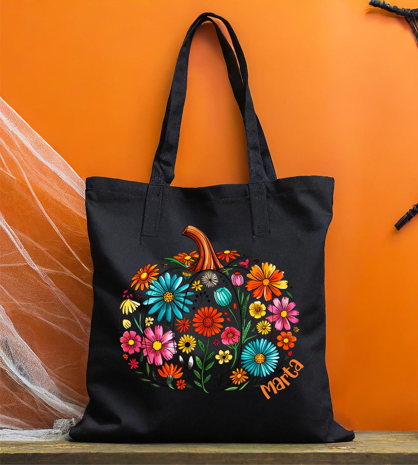 Bolsa de tela negra con calabaza de flores