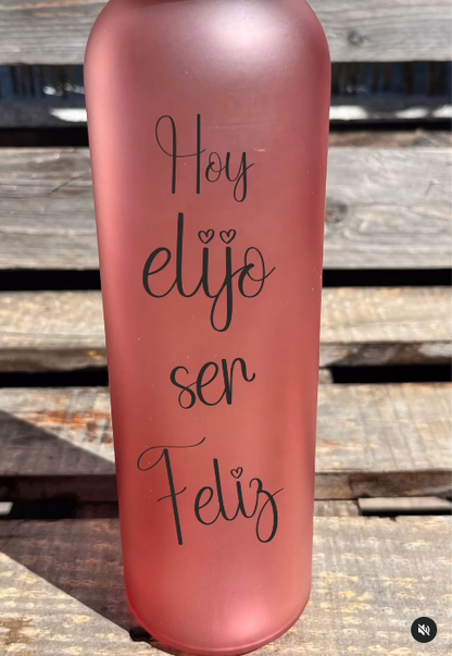 Botella roja de cristal con frase inspiradora