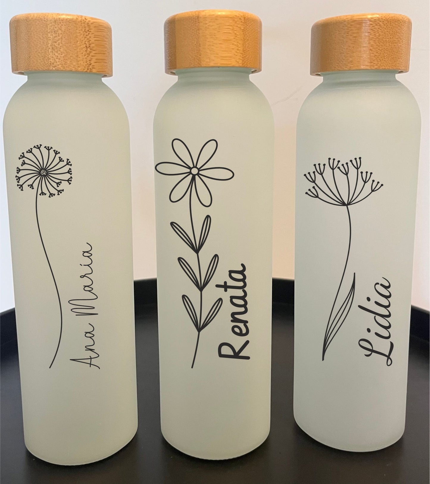 Juego de tres botellas de cristal con diseño de flores
